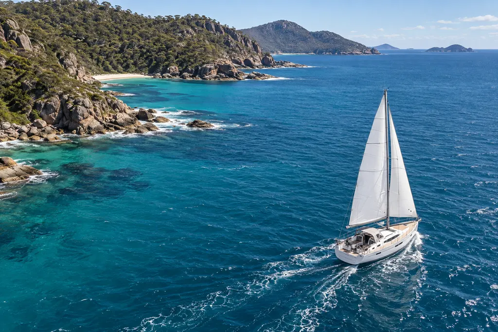 AI illustration of a sailing yacht passing a wooded Australian-style headland